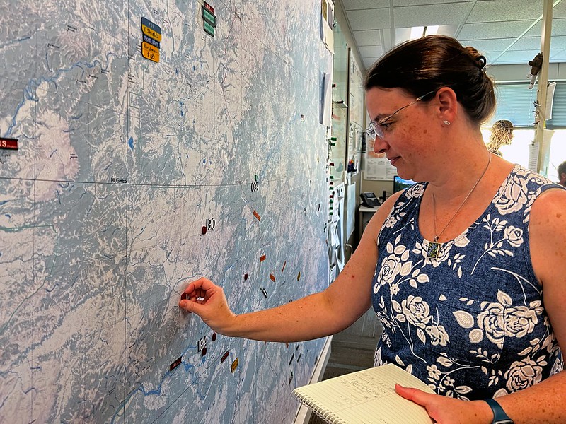 Photo by Beth Ipsen (BLM) of dispatch center manager plotting on map